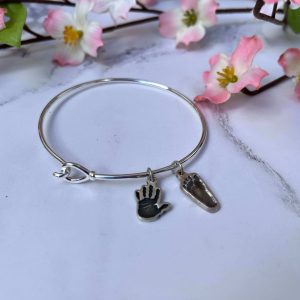 Silver hook and loop bangle with shaped hand or footprint